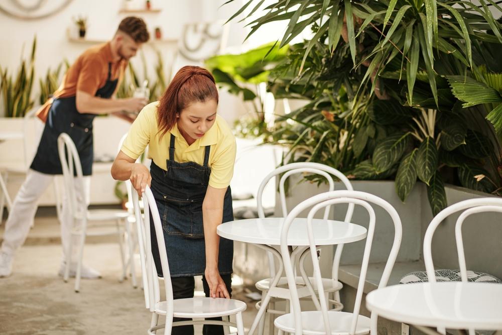 Cafe,Waiters,Bringing,Tables,And,Chairs,Outside,For,Summer,Season