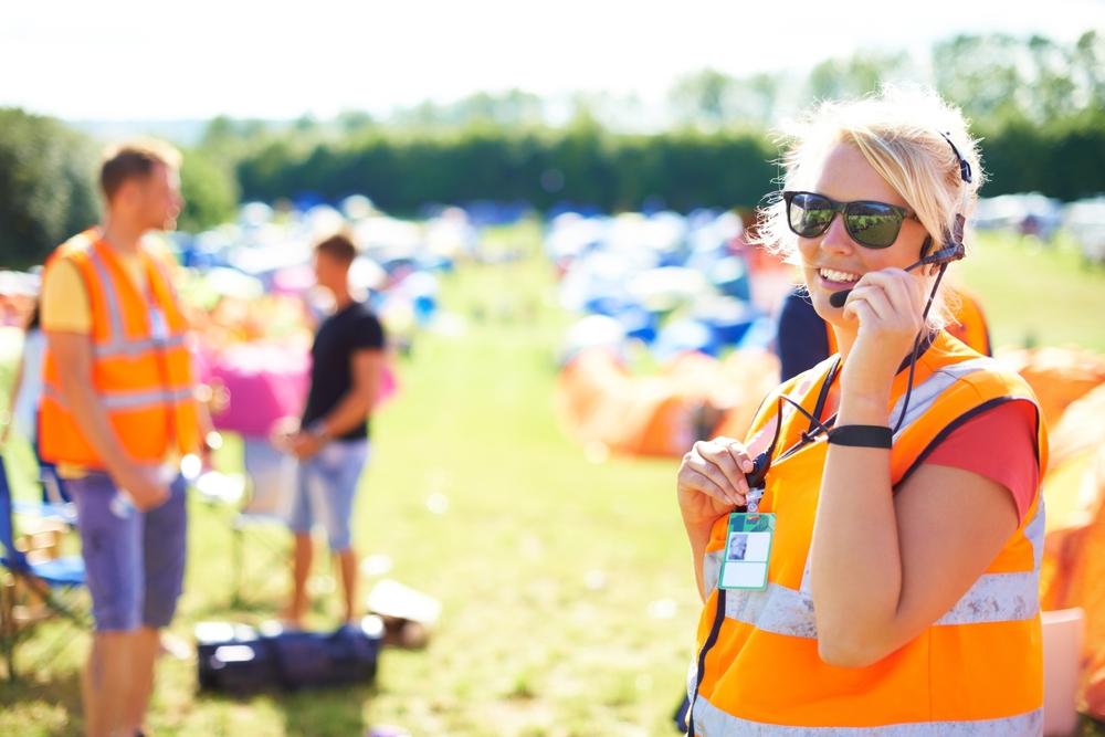 Festival,Security,,Communication,And,A,Woman,Outdoor,On,A,Grass